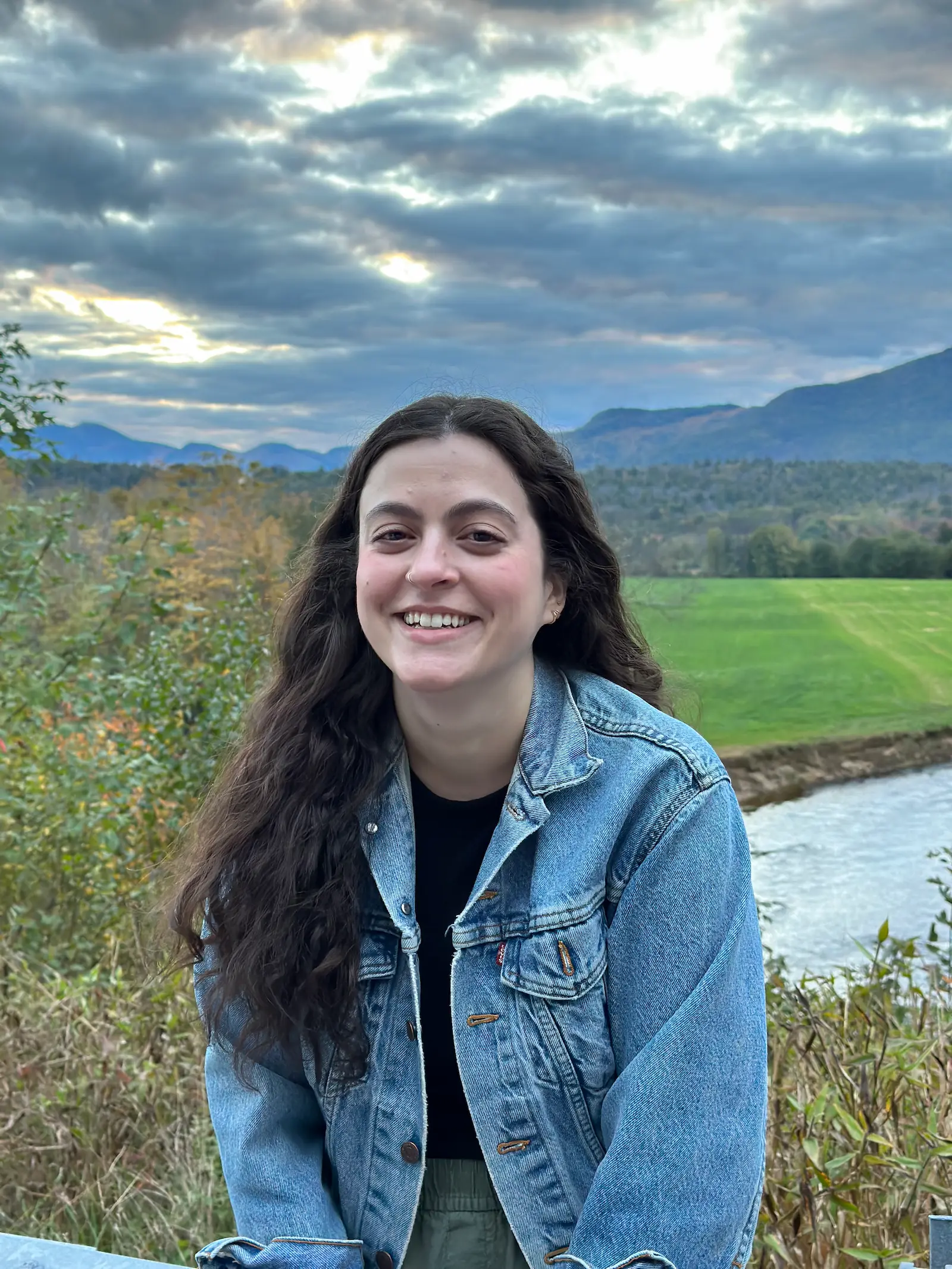 Asha smiling at a scenic overlook on the White Mountain Highway in North Conway, New Hampshire.